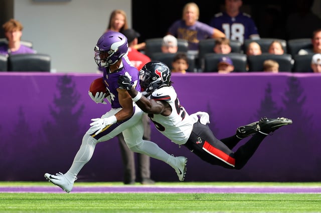 MINNEAPOLIS, MINNESOTA - AUGUST 09: Rondale Moore #4 of the Minnesota Vikings is tackled by Jamal Hill #56 of the Houston Texans in the second quarter during the NFL Preseason 2025 game between Houston Texans and Minnesota Vikings at U.S. Bank Stadium on August 09, 2025 in Minneapolis, Minnesota.