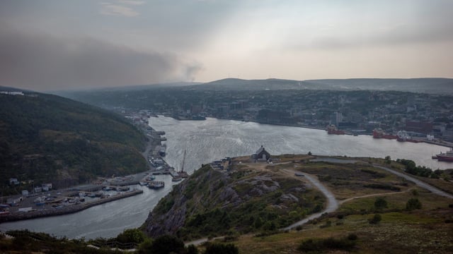 Smoke from a nearby wildfire is visible in this handout photo, from Signal Hill, in St. John’s, N.L., on Monday, Aug. 11, 2025. THE CANADIAN PRESS/Handout — Elling Lien (Mandatory Credit)