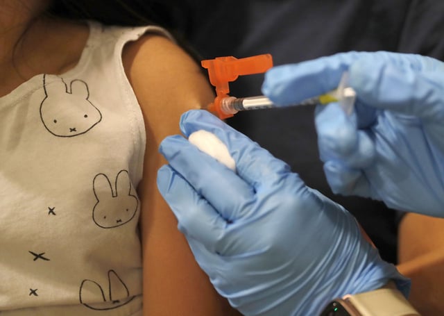 A child gets her Covid-19 vaccination a licensed vocational nurse at the Santa Clara County Fairgrounds in San Jose, Calif., on Tuesday, June 21, 2022.