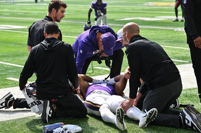 Aug 9, 2025; Minneapolis, Minnesota, USA; Minnesota Vikings wide receiver Rondale Moore (4) is attended to by head coach Kevin O'Connell and trainers after suffering a lower leg injury during the second quarter against the Houston Texans at U.S. Bank Stadium. Mandatory Credit: Jeffrey Becker-Imagn Images