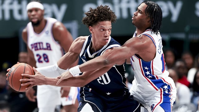 Mar 16, 2025; Dallas, Texas, USA; Dallas Mavericks forward Kessler Edwards (20) controls the ball as Philadelphia 76ers guard Ricky Council IV (14) defends during the second half at American Airlines Center. Mandatory Credit: Kevin Jairaj-Imagn Images