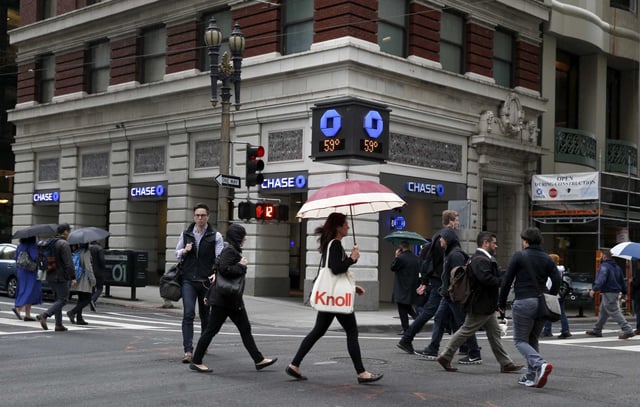 Office workers walk through the intersection of Montgomery and Sutter streets on the way to their jobs in the Financial District in San Francisco, in 2017. Office attendance dipped during the pandemic, but recent data suggests a surge in workers in the office.