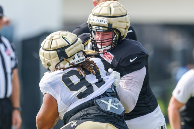 Jul 30, 2025; New Orleans, LA, USA;  New Orleans Saints center Will Clapp (76) blocks defensive tackle Khristian Boyd (97) during training camp at Ochsner Sports Performance Center. Mandatory Credit: Stephen Lew-Imagn Images/File Photo