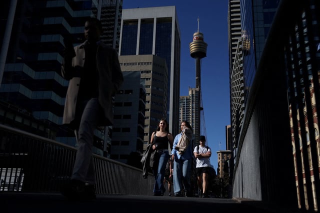 People cross a bridge near the Sydney Tower Eye in the Central Business District (CBD), Sydney, Australia, July 9, 2025. REUTERS/Hollie Adams/File Photo