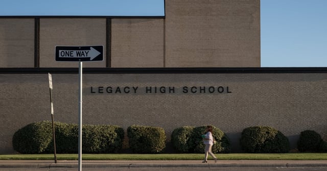 A Midland ISD employee walks past the front of Legacy High School on Thursday, Aug. 7, 2025, in Midland.