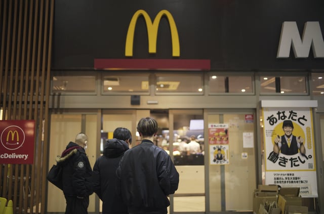 FILE - People stands outside a McDonald's store in Tokyo, March 15, 2024. (AP Photo/Hiro Komae, File)