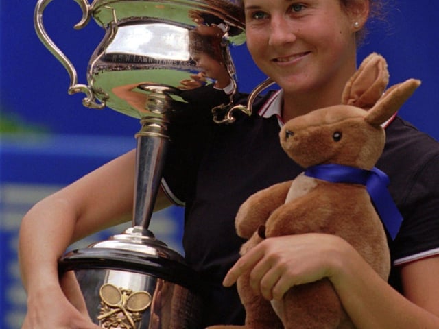 FILE - USA's Monica Seles holds the trophy and a toy Kangaroo after winning the women's final over Germany's Anke Huber at the Australian Open tennis Championships in Melbourne, Jan. 27, 1996. (AP Photo/Steve Holland, file)