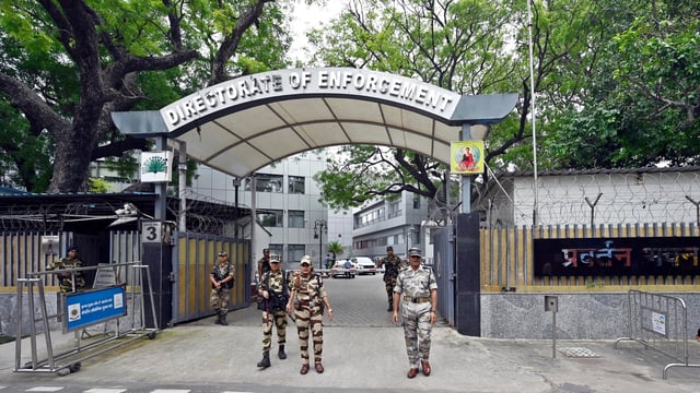Security personnel stand guard outside the Enforcement Directorate (ED) office in New Delhi.