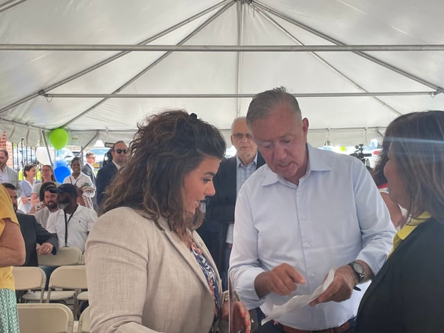 New Britain Mayor Erin Stewart and Gov. Ned Lamont could face each other in November 2026 in the battle for governor if they both win primaries next year. Here, they confer under the tent at the grand opening of The Ellis Block in New Britain, a 154-unit affordable housing development. (Photo by Christopher Keating/Hartford Courant)