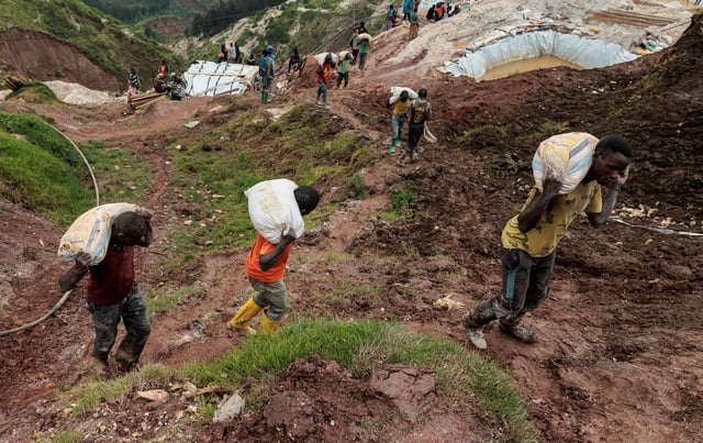 Labourers carry sacks of ore at the Rubaya coltan mine, in the town of Rubaya, which is controlled by M23 rebels, in the eastern Democratic Republic of Congo March 24, 2025. REUTERS/Zohra Bensemra