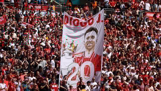 Liverpool fans with a banner in memory of Diogo Jota inside the stadium