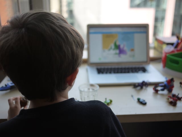 A boy participates in an online lesson for his kindergarten class while schools remain closed to help slow the spread of COVID-19, in Chicago, Ill., on April 3, 2020.