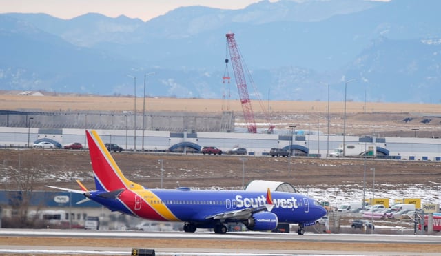 A Southwest Airlines jetliner head down a runway for take off from Denver International Airport Tuesday, Dec. 27, 2022, in Denver. (AP Photo/David Zalubowski)