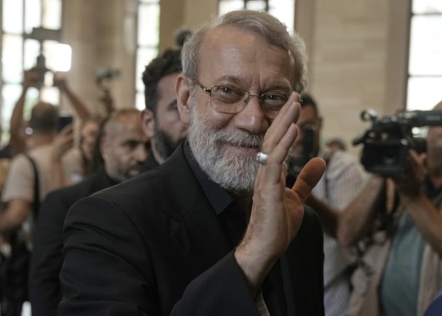 Iranian Secretary of Supreme National Security Council Ali Larijani, greets journalists upon his arrival to meet with the Lebanese parliament speaker Nabih Berri, in Beirut, Lebanon, Wednesday, Aug. 13, 2025. (AP Photo/Bilal Hussein)