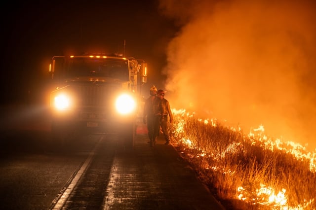 The 120,650-acre Lee fire burns alongside a road in Rio Blanco County on Tuesday, Aug. 12. The fire was 4% contained Tuesday evening. (Photo provided by Elk and Lee Fire Information)