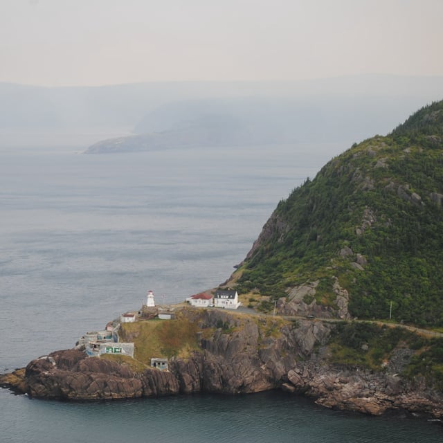Wildfire smoke is seen blanketing Newfoundland's coast, south of the lighthouse at Fort Amherst, in St. John's, N.L., on Monday, Aug. 11, 2025. THE CANADIAN PRESS/Sarah Smellie