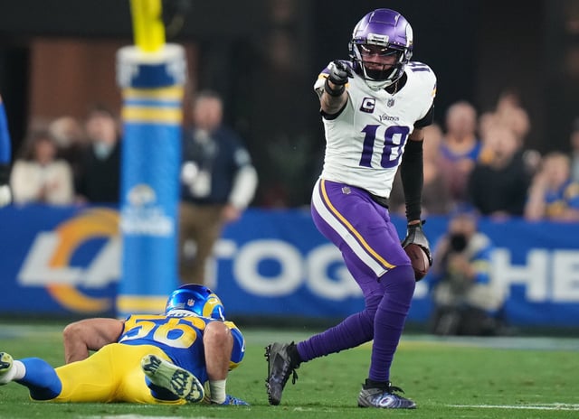Minnesota Vikings receiver Justin Jefferson signals a first down after a catch against the Los Angeles Rams during their playoff game at State Farm Stadium.