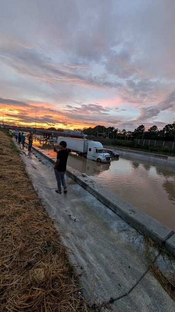Vehicles stand on a flooded road, in Chattanooga, Tennessee, on Aug.12, 2025.