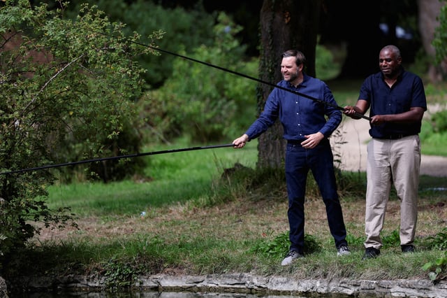U.S. Vice President JD Vance fishes with British Foreign Secretary David Lammy at Chevening House in Sevenoaks, Britain, August 8, 2025. REUTERS/Suzanne Plunkett/Pool/File Photo