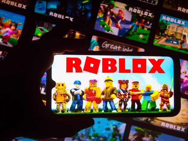 In this photo illustration the Roblox logo seen displayed on a smartphone.