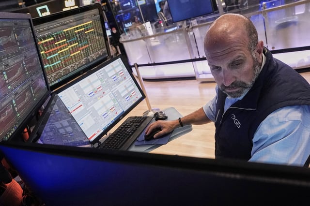 Specialist James Denaro works at his post on the floor of the New York Stock Exchange, Tuesday, Aug. 12, 2025. (AP Photo/Richard Drew)