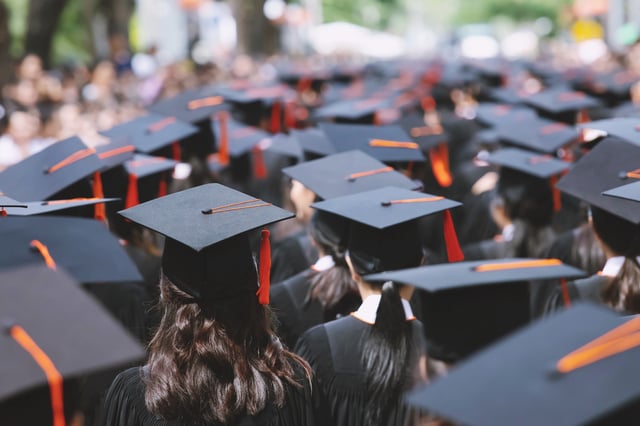 Stock image of college students attending their graduation ceremony.