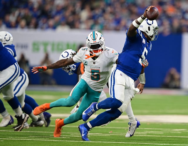 Oct 20, 2024; Indianapolis, Indiana, USA; Miami Dolphins cornerback Jalen Ramsey (5) gets a hand on Indianapolis Colts quarterback Anthony Richardson (5) during the second quarter at Lucas Oil Stadium. Mandatory Credit: Marc Lebryk-Imagn Images/File Photo