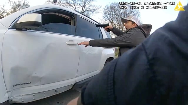 A still image of a video released by the Civilian Office of Police Accountability shows a group of Chicago police officers surrounding a vehicle driven by Dexter Reed, 26, moments before an &#34;exchange of gunfire&#34; in which Reed was fatally shot on March 21, 2024 in the Humboldt Park neighborhood. (Chicago Police Department)