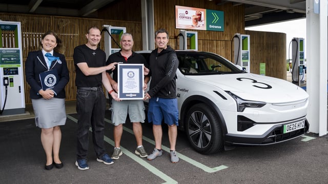 One woman and three men stand next to a polestar 3, holding a certificate.