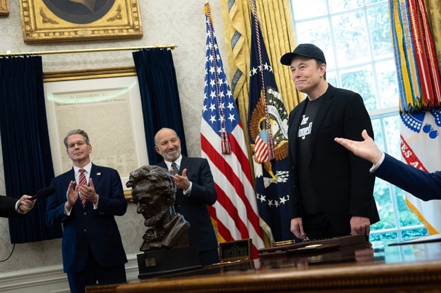 Treasury Secretary Scott Bessent and Commerce Secretary Howard Lutnick applaud for Elon Musk inside the Oval Office at the White House.