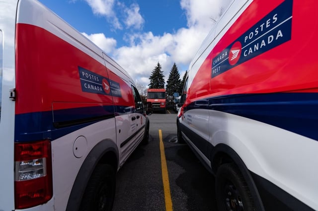Canada Post mail trucks are seen parked in their distribution centre in Montreal, Wednesday, Nov. 27, 2024. THE CANADIAN PRESS/Christinne Muschi