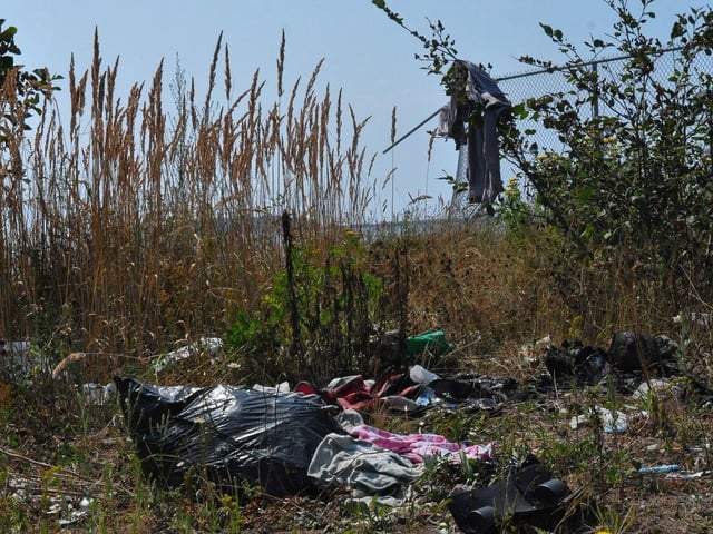 Debris from an encampment lies scattered on the ground in Saint John's south end. Due to concerns over wildfires a number of residents at five encampments and within the woods at Rockwood Park have been temporarily relocated to a shelter. 