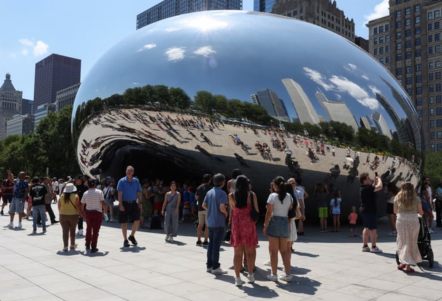 People visit Cloud Gate, commonly known as The Bean, at Millennium Park, Aug. 9, 2025, in Chicago. (John J. Kim/Chicago Tribune)