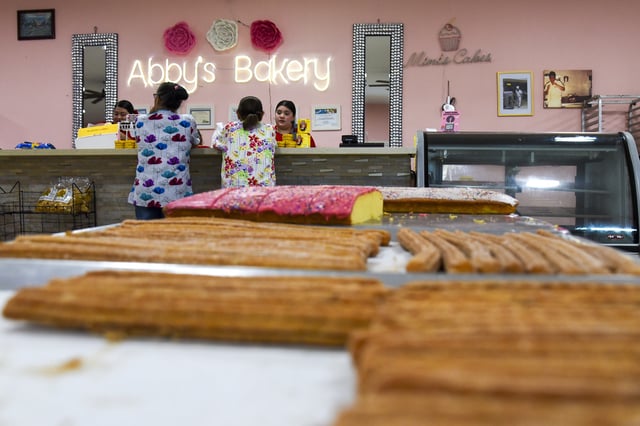 FILE - Customers visit Abby's Bakery after the owners reopened their doors following their arrest for allegedly harboring unauthorized workers in their building in Los Fresnos, Texas, March 4, 2025. (AP Photo/Valerie Gonzalez, File)