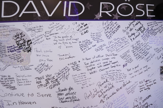 CORRECTS THAT OFFICER WAS KILLED, NOT WOUNDED - A memorial is seen in the aftermath of a shooting near the CDC where DeKalb County Police Officer David Rose was killed while responding, Wednesday, Aug. 13, 2025, in Atlanta. (AP Photo/Mike Stewart)