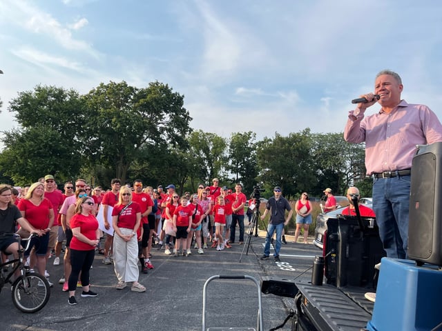 Ross Berkley, president of the Naperville School District 203 teachers union, speaks to a crowd of several hundred educators and community members at a Monday rally held prior to the school board meeting. The union is frustrated by the lack of movement in talks for a new contract, members said. (Michelle Mullins/Naperville Sun)