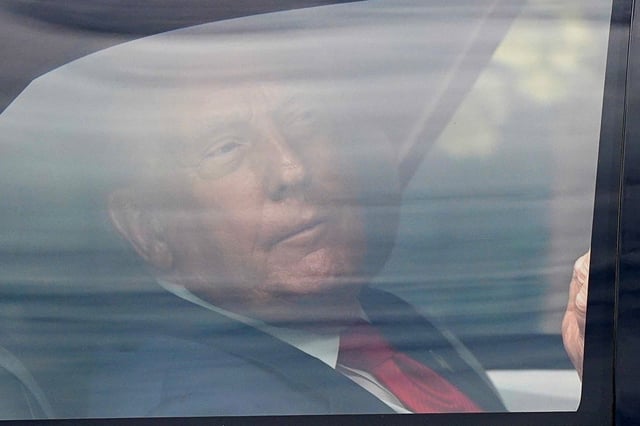 U.S. President Donald Trump travels in a vehicle as part a motorcade, as he returns to the White House from a visit to the Kennedy Center, in Washington D.C., U.S., August 13, 2025. REUTERS/Elizabeth Frantz/File photo