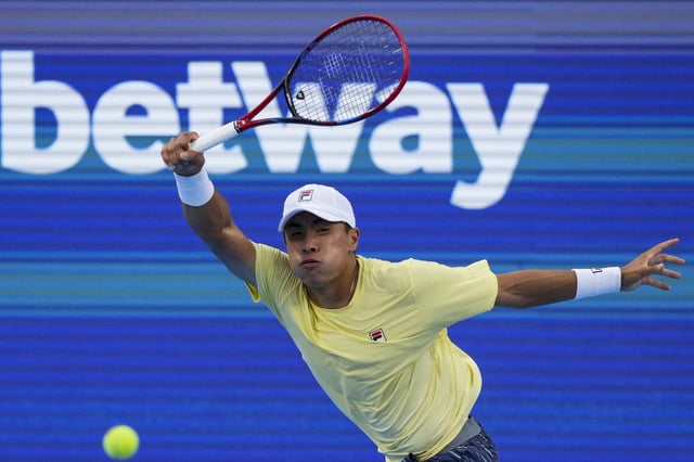 Aug 12, 2025; Cincinnati, OH, USA; Brandon Nakashima (USA) returns a shot against Alexander Zverev (GER) during the Cincinnati Open at the Lindner Family Tennis Center. Mandatory Credit: Aaron Doster-Imagn Images