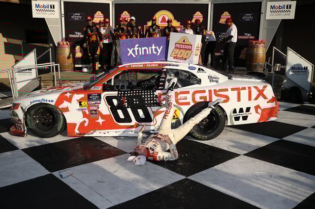 Connor Zilisch, driver of the #88 Registix Chevrolet, slips and falls off his car in victory lane after winning the NASCAR Xfinity Series Mission 200 at The Glen at Watkins Glen International on August 09, 2025 in Watkins Glen, New York.
