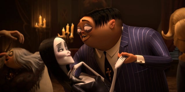 Gomez holds Morticia in a loving embrace in The Addams Family.