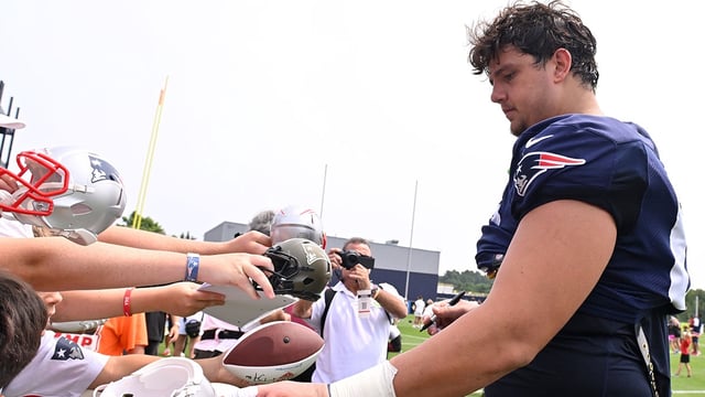 Aug 6, 2025; Foxborough, MA, USA; New England Patriots offensive tackle Will Campbell (66) signs autographs after training camp at Gillette Stadium. Mandatory Credit: Eric Canha-Imagn Images.