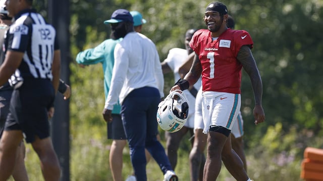 Aug 8, 2025; Lake Forest, IL, USA; Miami Dolphins quarterback Tua Tagovailoa (1) walks on the field during joint training camp practice with the Chicago Bears ahead of Sunday&#39;s preseason opener. Mandatory Credit: Kamil Krzaczynski-Imagn Images