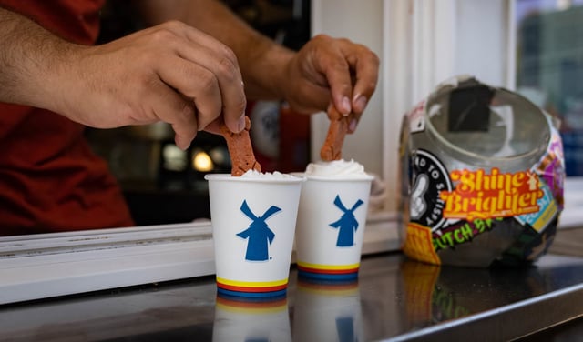 A barista prepares dog treat drinks for a customer at the drive-through window of a Dutch Bros. Coffee location in Beaverton, Oregon, U.S., on Thursday, June 24, 2021.