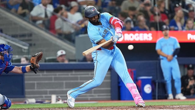 Aug 12, 2025; Toronto, Ontario, CAN; Toronto Blue Jays first baseman Vladimir Guerrero Jr. (27) hits a single against the Chicago Cubs during the fourth inning at Rogers Centre. Mandatory Credit: Nick Turchiaro-Imagn Images