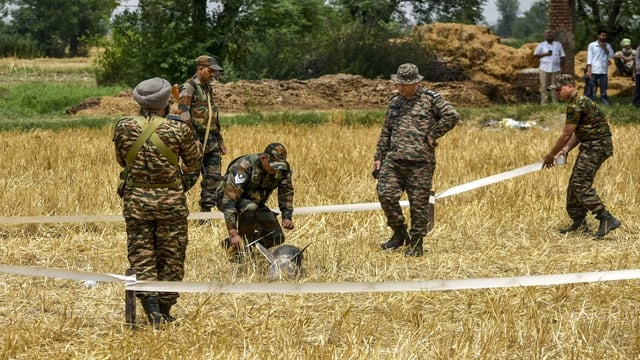 Security personnel secures an area where metal debris was found at an open field at Makhan Windi village, amid tension between India and Pakistan in the wake of Operation Sindoor, in Amritsar district, Punjab. PTI