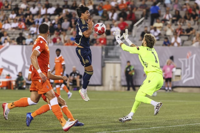 Forge FC goalkeeper Jassem Koleilat (1) stops a deflected shot from Vancouver Whitecaps' Mathias Nicolas Laborda Malse — ido (2) during second half Canadian Championship semifinal soccer action in Hamilton, on Thursday, August 13, 2025. THE CANADIAN PRESS/Nick Iwanyshyn