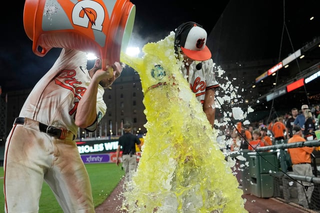 BALTIMORE, MARYLAND - AUGUST 13: Jackson Holliday #7 of the Baltimore Orioles gets doused with Gatorade by teammate Jordan Westburg #11 after Holliday hit a walk-off double to win the game against the Seattle Mariners at Oriole Park at Camden Yards on August 13, 2025 in Baltimore, Maryland. (Photo by Jess Rapfogel/Getty Images)