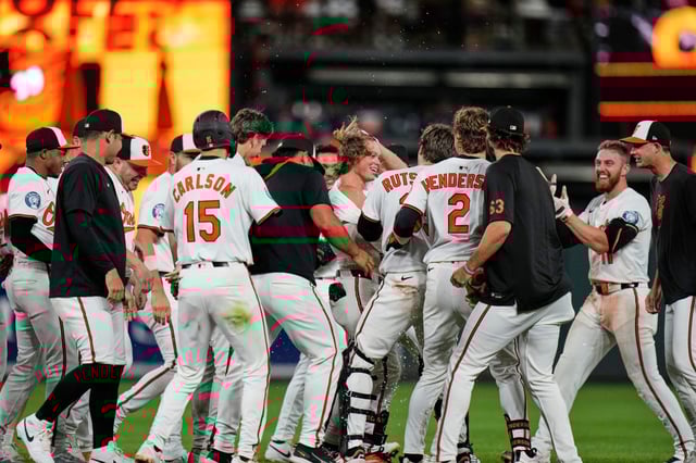 Baltimore Orioles’ Jackson Holliday (7) celebrates with teammates after hitting a walk-off RBI double during the ninth inning of a baseball game against the Seattle Mariners, Wednesday, Aug. 13, 2025, in Baltimore. (AP Photo/Stephanie Scarbrough)