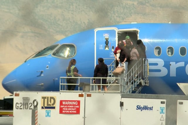 Passengers leave a Breeze Airways flight after it was diverted to Grand Junction, Colo., on Wednesday. 