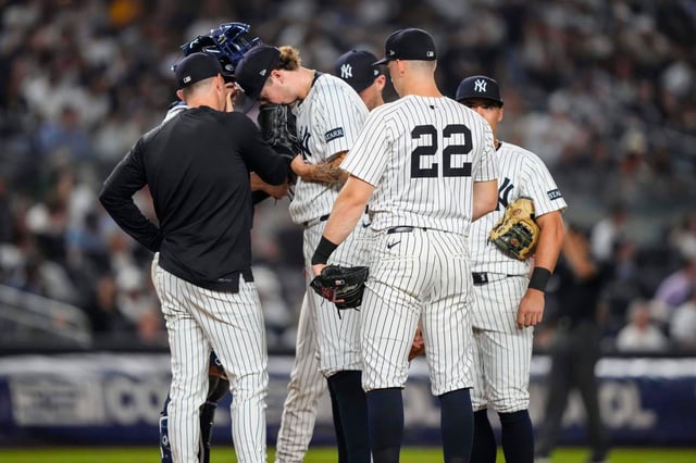 New York Yankees pitcher Cam Schlittler and teammates talk during the fourth inning of a baseball game against the Minnesota Twins, Wednesday, Aug. 13, 2025, in New York. (AP Photo/Yuki Iwamura)
